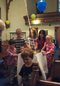 The children roll the Bible to the front of the sanctuary